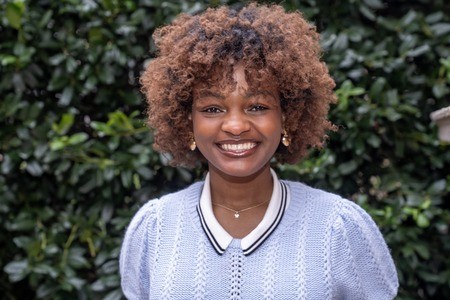 Woman smiling outdoors.