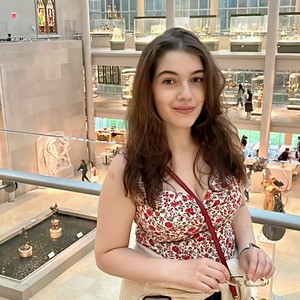 Woman smiling inside a museum.