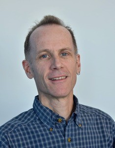 Portrait of smiling man in blue plaid.