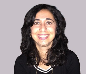 Portrait of smiling woman in business attire.