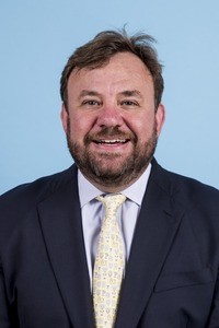 Smiling man in business attire.