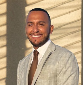 Portrait of smiling man in suit and tie.