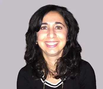 Portrait of smiling woman in business attire.